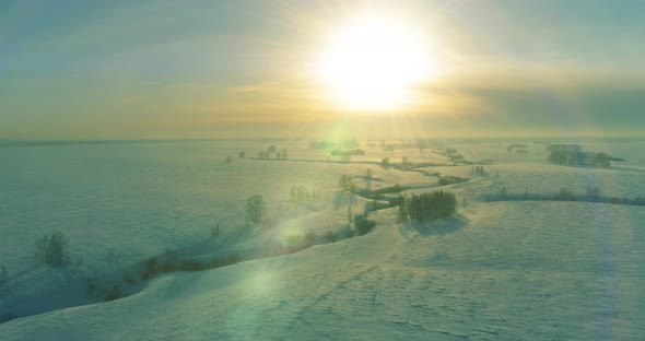 Aerial View of Cold Winter Landscape Arctic Field Trees Covered with Frost Snow Ice River and Sun