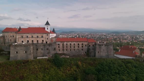 Aerial View of Medieval Castle on Mountain in Small European City at Cloudy Autumn Day