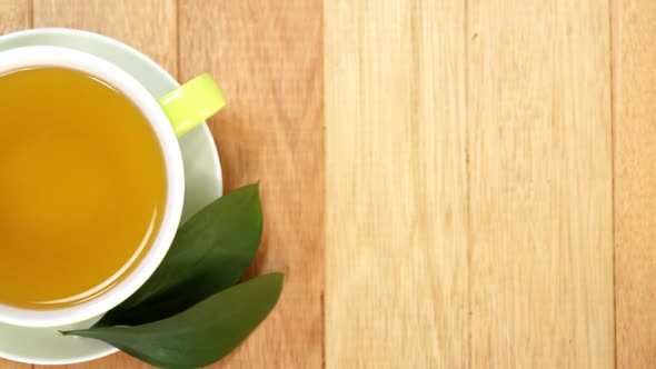 Close-up of tea cup with saucer and tea leaves