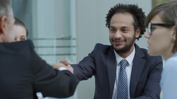 Partners Shaking Hands at Business Meeting in International Company