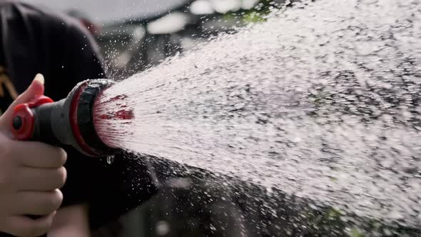 Close Up Shot of Garden Sprayer in Woman Hand Watering the Garden Bed