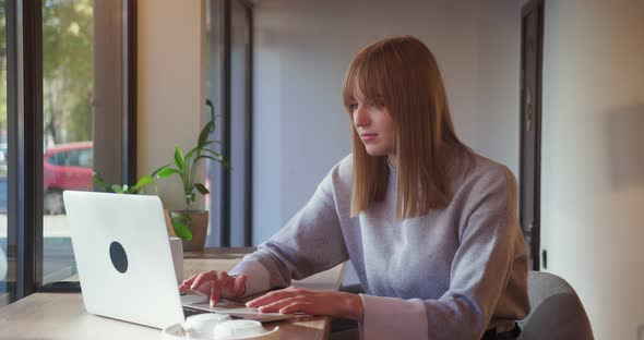 Attractive Young Female Student Using Laptop