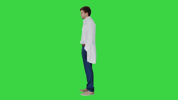 Sad Male Doctor Giving Bad News and Shaking His Head on a Green Screen, Chroma Key.