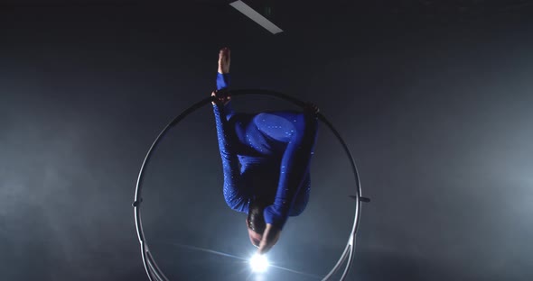 Gymnastics Performance in the Studio By a Young Woman in Blue Costume in a Hoop