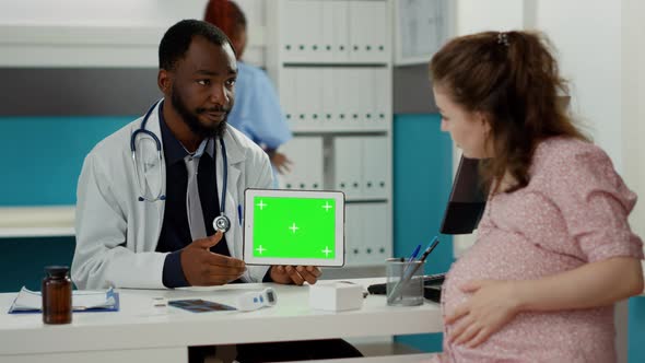 Male Specialist Holding Tablet with Horizontal Greenscreen