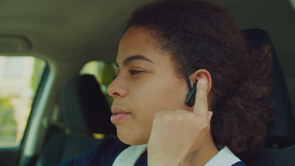 Black Woman in Car Talking Using Hands-free Device