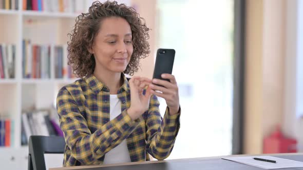 Attractive Young Mixed Race Woman Using Smartphone at Work