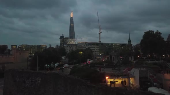 Aerial Drone Rising Above Wall Reveals The Shard Skyscraper in London UK Evening Night