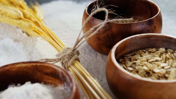 Wheat grains, sesame and flour in bowls