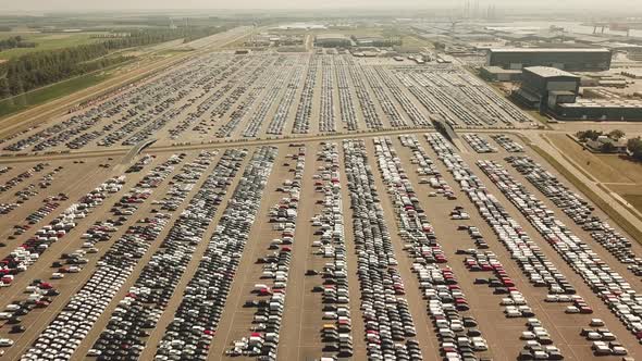 Many new and occasion Cars on a huge parking lot waiting for shipment, Aerial