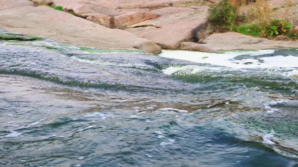 A Small Shining Stream Flows Among Smooth Wet and Dark Stones