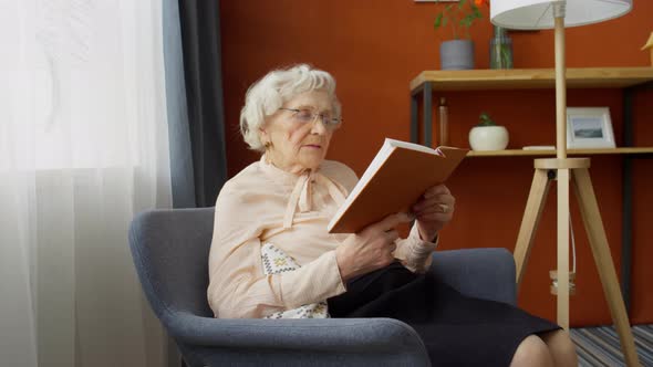 Elderly Woman Reading Book at Home