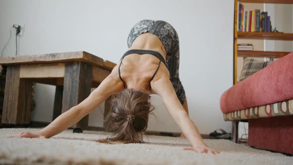 Woman Does Yoga and Stretching Exercises at Home