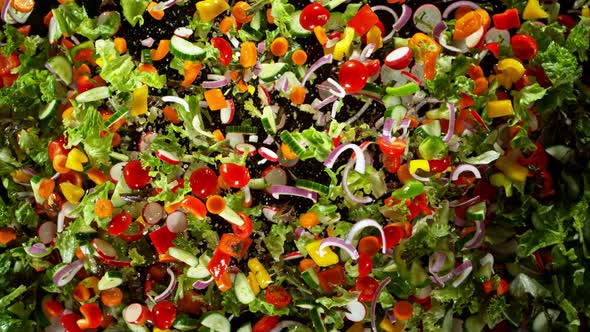 Super Slow Motion Shot of Flying Cuts of Colorful Fresh Vegetables and Water Drops at 1000fps.