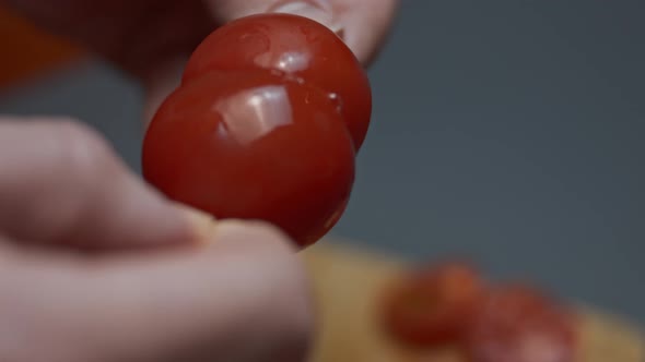 Uniting Two Halves of Cherry Tomatoes with a Wooden Skewer and Placing It on a Plate with Fried Egg