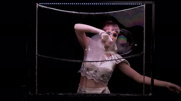 Young Girl Does Tricks with Soap Bubbles