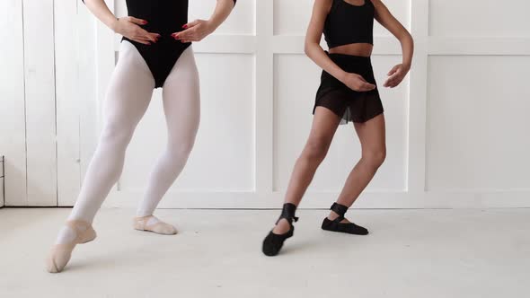 Woman Teaching African Girl How to Dance Ballet