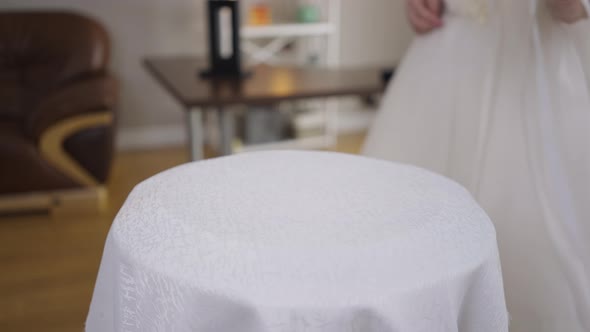 Closeup Table with Unrecognizable Bride in Wedding Dress Passing in Slow Motion Leaving Bridal