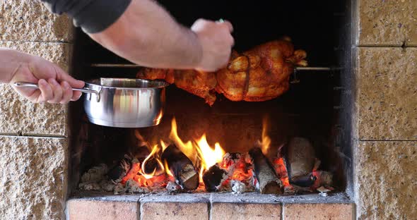 chicken roasting on a spit