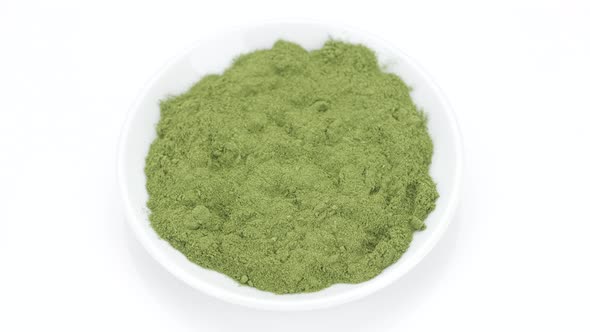 Super food. green powder superfood chlorella or spirulina isolated on white background