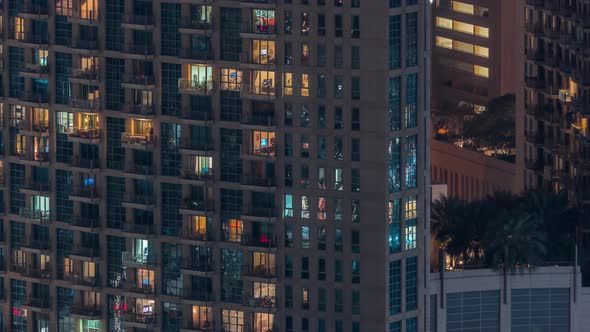 Windows in Highrise Building Exterior in the Late Evening with Interior Lights on Timelapse