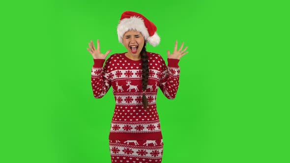 Sweety Girl in Santa Claus Hat Is Screaming. Green Screen