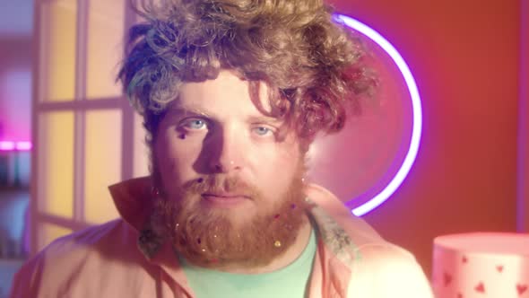 Man with Confetti on Beard Smiling and Dancing in Disco Room