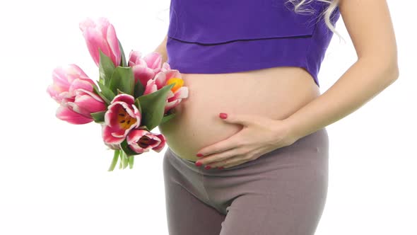 Pregnant Woman Holding Her Belly and Bouquet of Tulips, White, Closeup