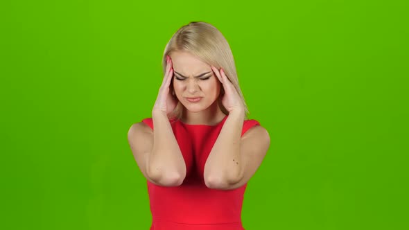 Woman in Red Dress Suffers From Headache and Does Massage