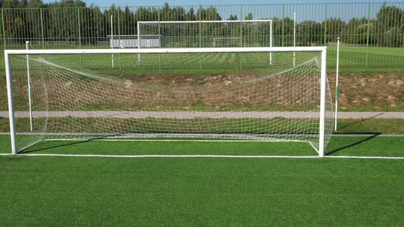 Top View of a Football Field with Green Grass Outdoors in Summer