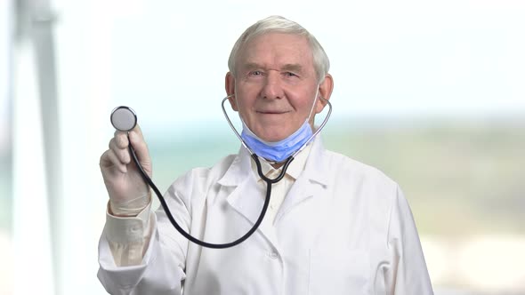 Old Senior Cheerful Doctor with Stethoscope.