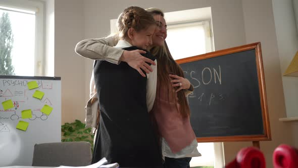 Happy Teacher Hugging Schoolgirls Returning From Vacations to School