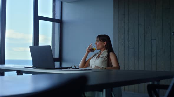 Manager Holding Whiskey Glass Resting in Office