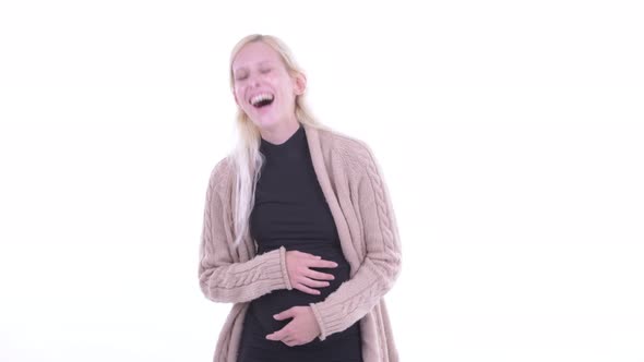 Happy Young Blonde Pregnant Woman Laughing and Pointing at Camera