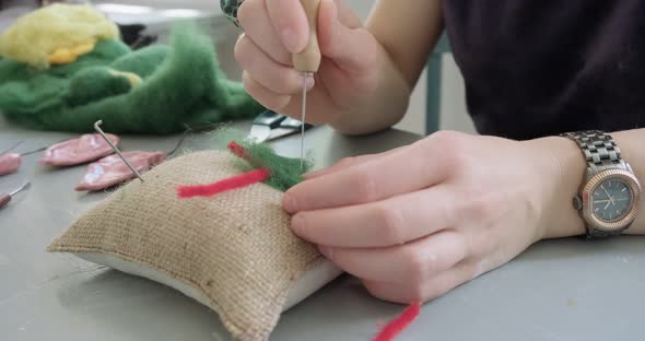 Woman Making Wool Art Doll Toy at Table Close Up. Female Sitting and Creating Ooak Doll at Home