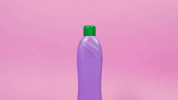 Purple Plastic Bottle with a Green Lid and Household Chemicals