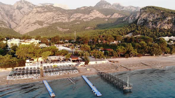 Aerial View of the Rows of Sun Loungers on the Sea Beach and a Large Hotel with Many Pools on the