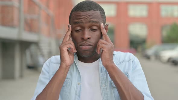 Outdoor Portrait of African Man Having Headache