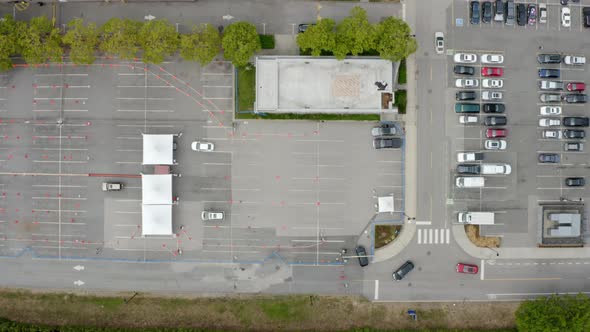 Cars Driving In At The Coronavirus Testing And Vaccine Site For Vaccination During Pandemic. aerial