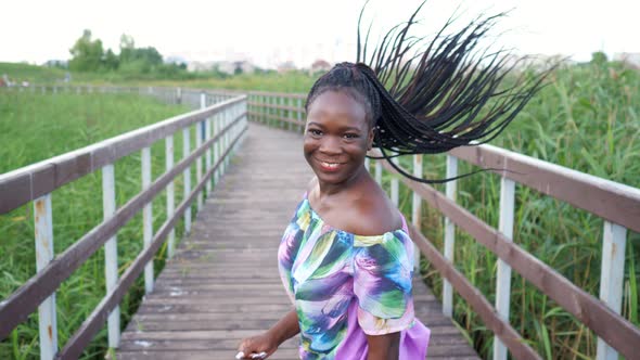 AfricanAmerican Woman with Cornrows Runs Along Bridge