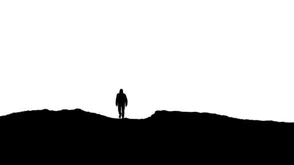 Man Walks Over Hill Silhouette