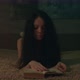 Woman Opening A Book In A Dimly Lit Room - VideoHive Item for Sale