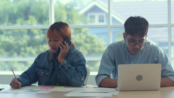 Group of business man and woman using mobile phone talking with customer at office.