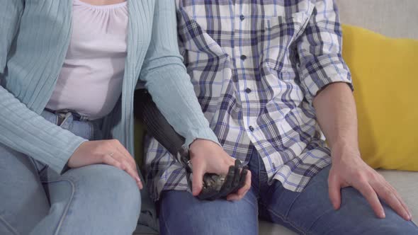 Young Woman Holds the Bionic Hand of Her Young Man