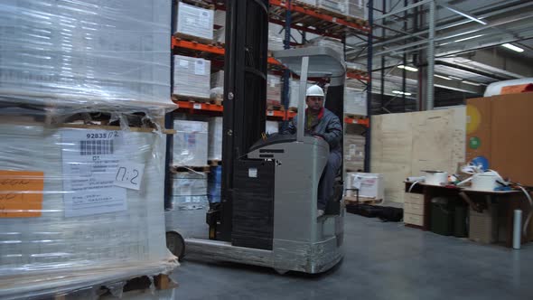 Forklift Rides Out of Pallets with Boxes
