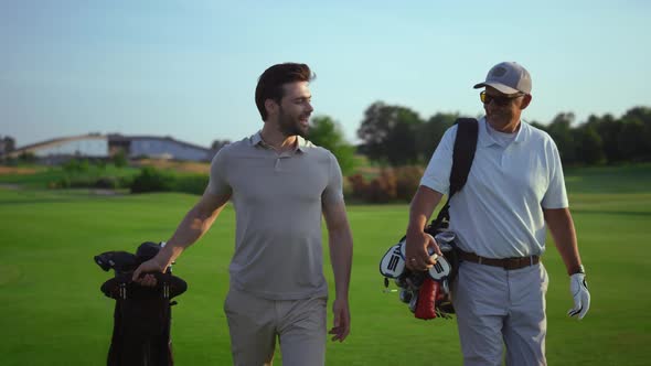 Successful Golfers Smiling Discuss Golf on Course