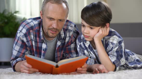 Caring Dad Helping His Schoolboy to Understand Difficult Subject, Homework