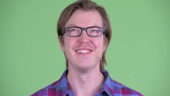 Face of Happy Young Handsome Hipster Man Thinking and Looking Up