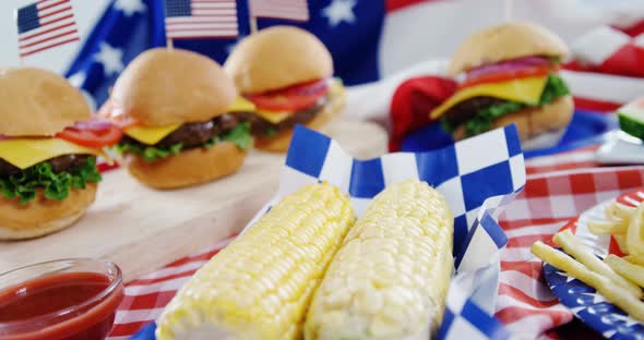 Hamburgers and french fries served on table with 4th july theme