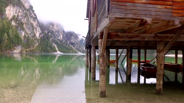 Stunning Pragser Wildsee lake and misty mountains in the Alps, Italy